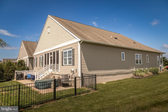 rear view of house featuring a patio area and a yard