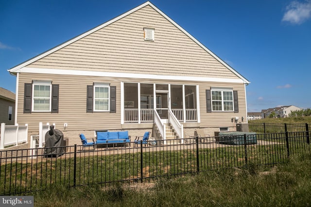 rear view of property with a yard and a sunroom