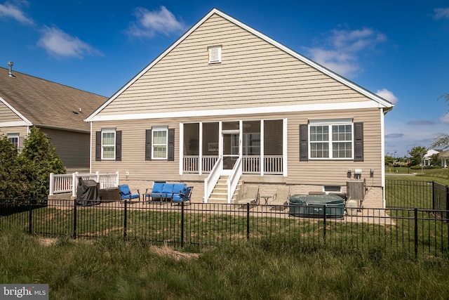 back of house with a lawn and a sunroom