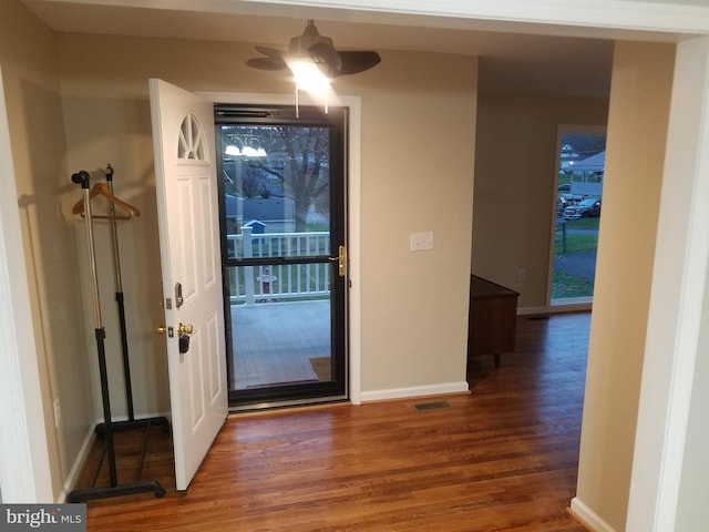 doorway with hardwood / wood-style flooring and ceiling fan