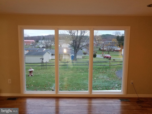 entryway with hardwood / wood-style floors and a healthy amount of sunlight