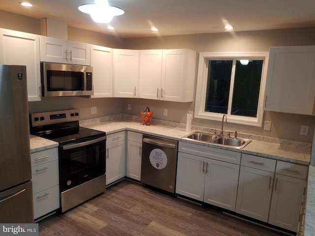 kitchen featuring white cabinets, dark hardwood / wood-style flooring, stainless steel appliances, and sink