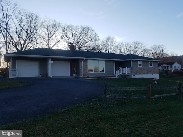 ranch-style home with a garage and a front yard