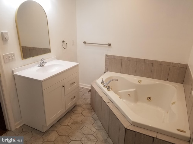 bathroom featuring tile patterned floors, tiled tub, and vanity