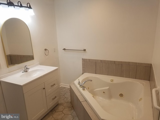 bathroom featuring tile patterned floors, tiled tub, and vanity