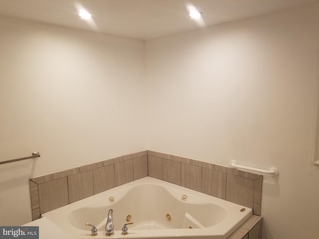 bathroom with a relaxing tiled tub