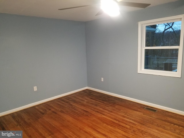 spare room featuring hardwood / wood-style floors and ceiling fan