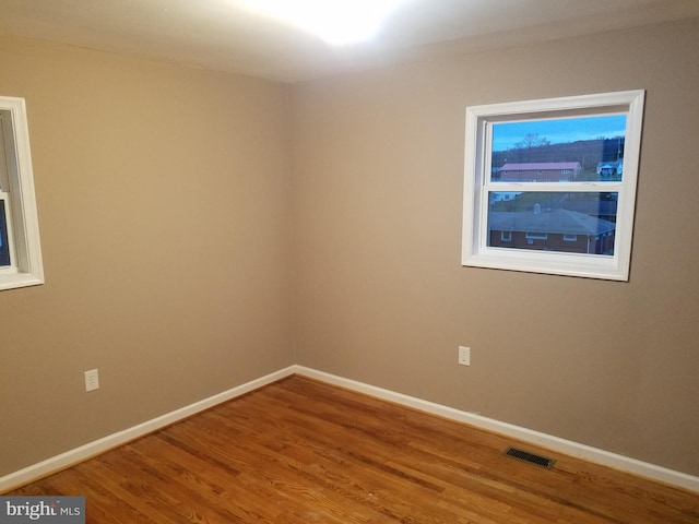 spare room with hardwood / wood-style floors