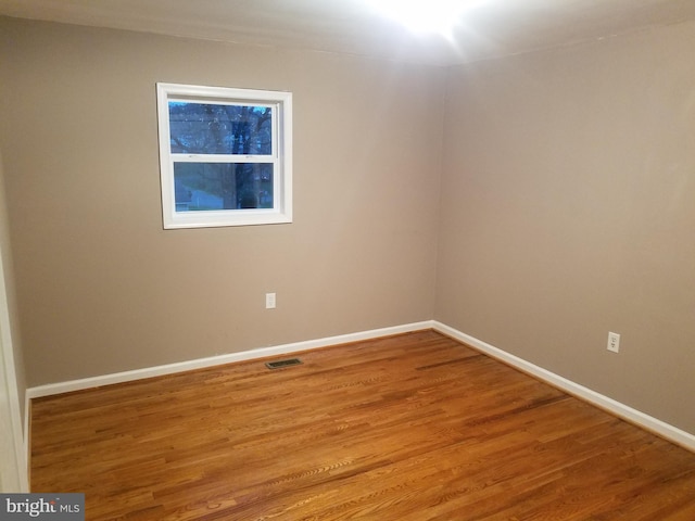 empty room with hardwood / wood-style flooring