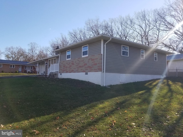 view of home's exterior with a lawn