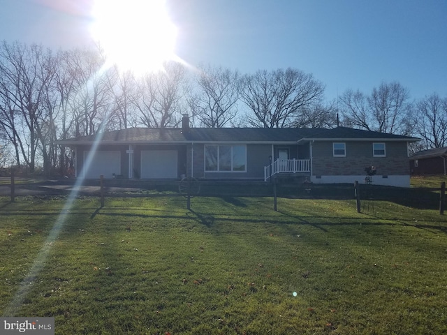 ranch-style home with a garage and a front lawn