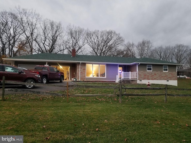 view of front of house with a front yard and a garage