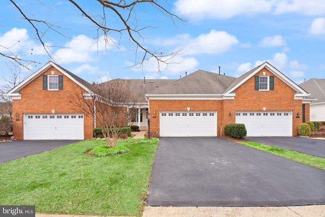 traditional-style house featuring driveway, a shingled roof, a front yard, and brick siding