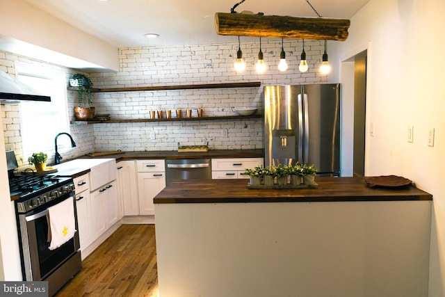 12507 Greenly St, Silver Spring, MD 20906 - kitchen with wooden counters, stainless steel appliances, open shelves, and decorative backsplash