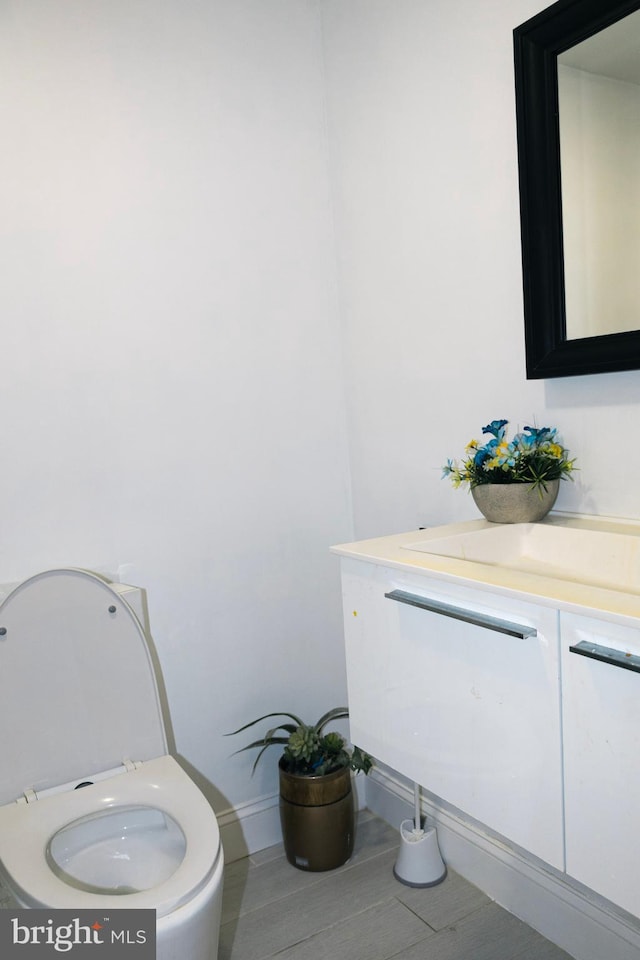 12507 Greenly St, Silver Spring, MD 20906 - half bathroom featuring vanity, toilet, and baseboards