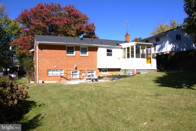 12507 Greenly St, Silver Spring, MD 20906 - rear view of property featuring brick siding, a lawn, a chimney, a patio area, and a sunroom
