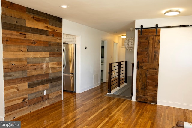 12507 Greenly St, Silver Spring, MD 20906 - empty room featuring wood finished floors, a barn door, baseboards, and recessed lighting