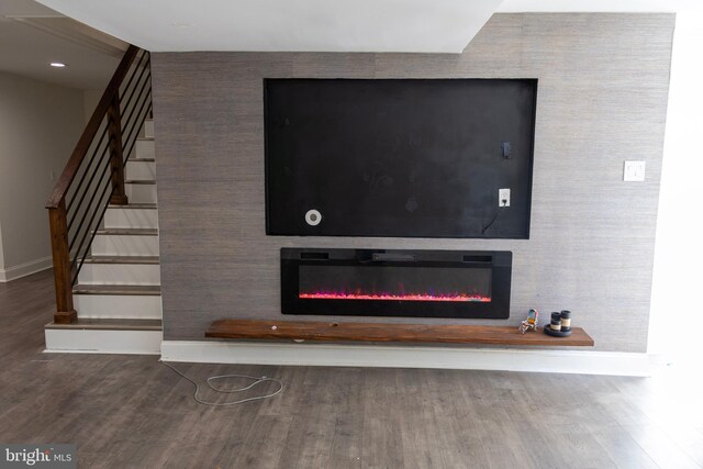 12507 Greenly St, Silver Spring, MD 20906 - detailed view of baseboards, wood finished floors, and a glass covered fireplace