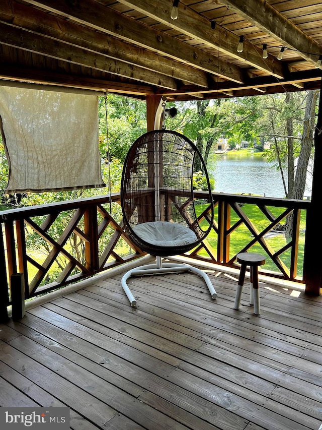 wooden deck featuring a water view