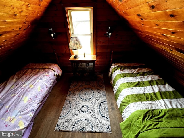 bedroom featuring wood walls, wood-type flooring, and lofted ceiling