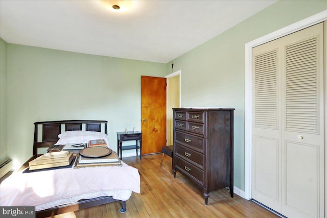 bedroom featuring a closet and light wood-type flooring