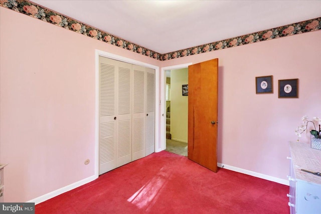 unfurnished bedroom with carpet and a closet