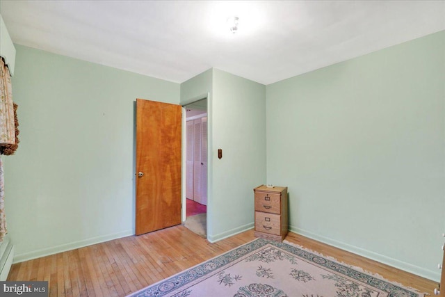 unfurnished bedroom with light wood-type flooring