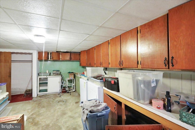 interior space featuring a drop ceiling and washing machine and dryer