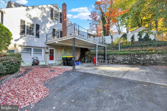 view of front of home featuring a garage and a balcony