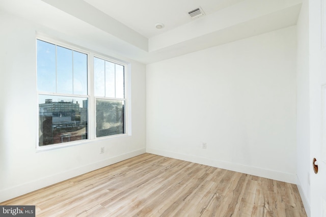 spare room featuring light hardwood / wood-style floors