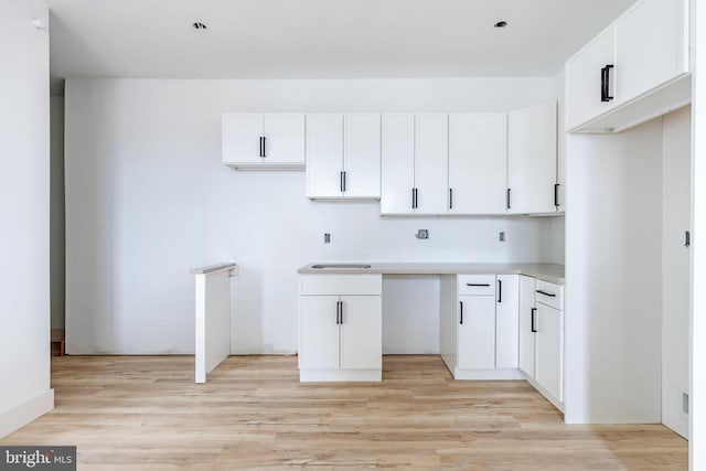 kitchen featuring light hardwood / wood-style floors and white cabinets