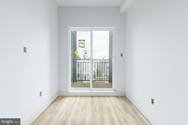 spare room featuring light hardwood / wood-style flooring