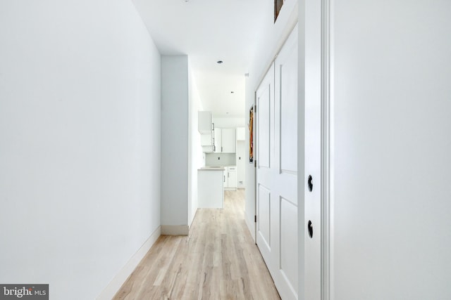 hall with light hardwood / wood-style floors