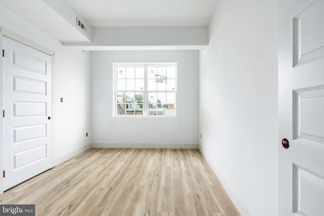 spare room with light hardwood / wood-style floors