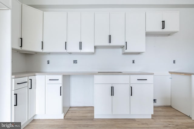 kitchen featuring light wood-type flooring and white cabinetry