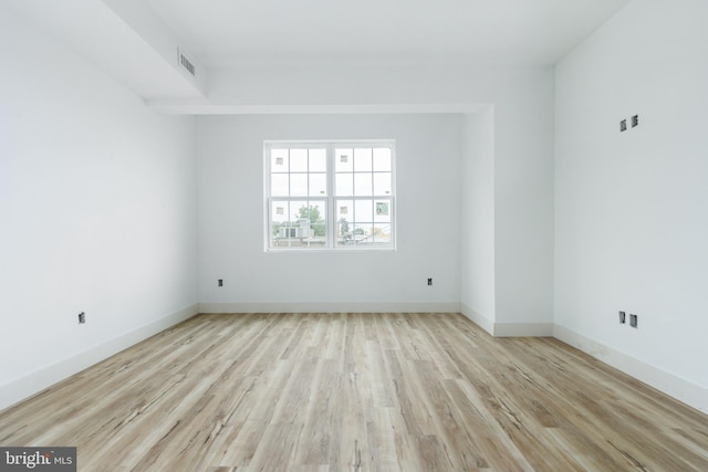 spare room with light hardwood / wood-style flooring