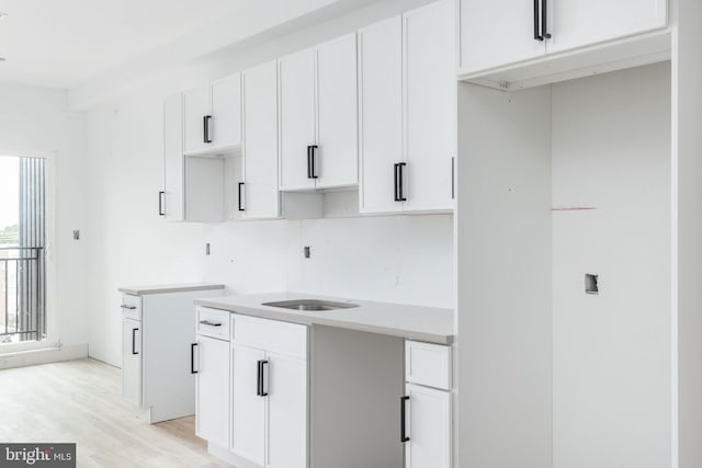 kitchen featuring light hardwood / wood-style floors and white cabinetry