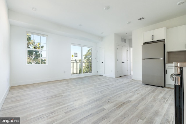 unfurnished living room featuring light hardwood / wood-style flooring