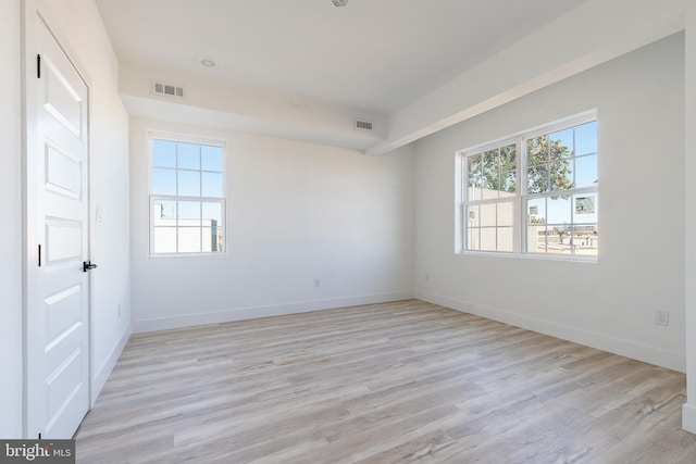 unfurnished room featuring light hardwood / wood-style flooring and a healthy amount of sunlight