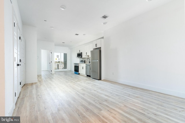 unfurnished living room featuring light hardwood / wood-style floors