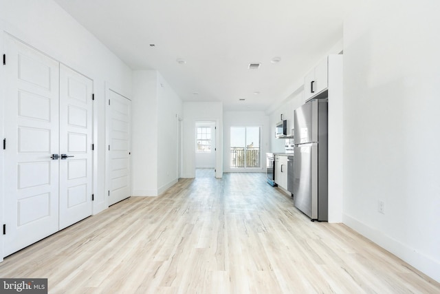 unfurnished living room featuring light hardwood / wood-style flooring