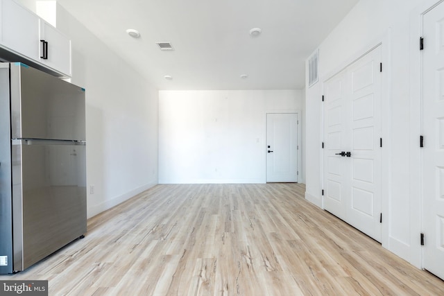 spare room featuring light hardwood / wood-style floors