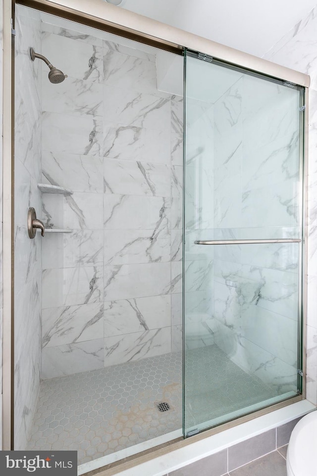 bathroom with a shower with shower door