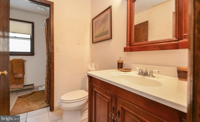 bathroom featuring vanity, a baseboard radiator, toilet, and tile patterned flooring