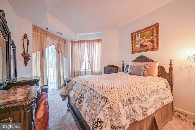 carpeted bedroom featuring a textured ceiling