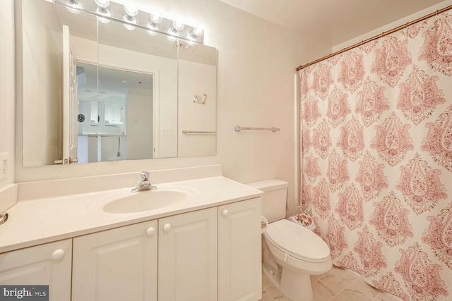 bathroom featuring toilet, curtained shower, vanity, and tile patterned floors