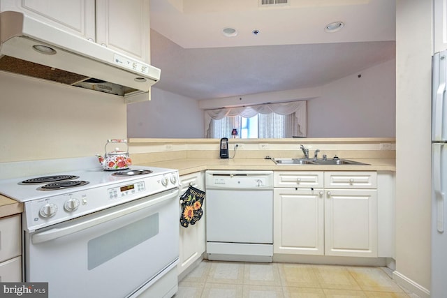 kitchen featuring kitchen peninsula, white cabinetry, sink, and white appliances