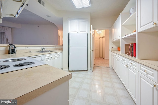 kitchen with sink, white cabinetry, and white appliances