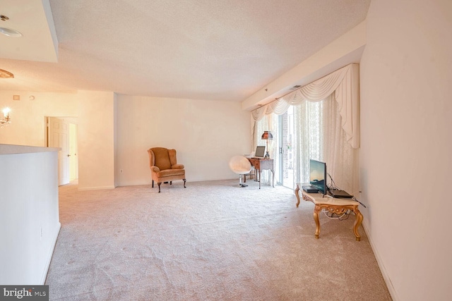 living area featuring a textured ceiling and light colored carpet