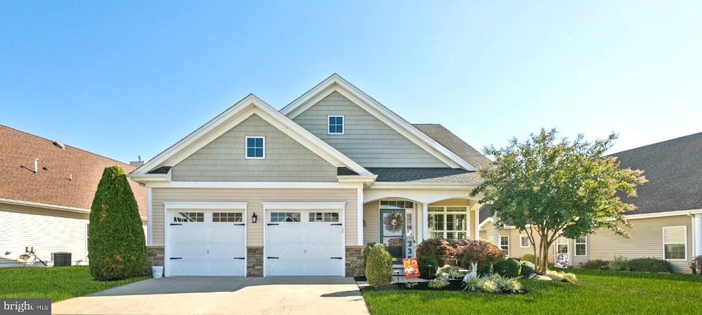 craftsman-style house featuring a front lawn and a garage